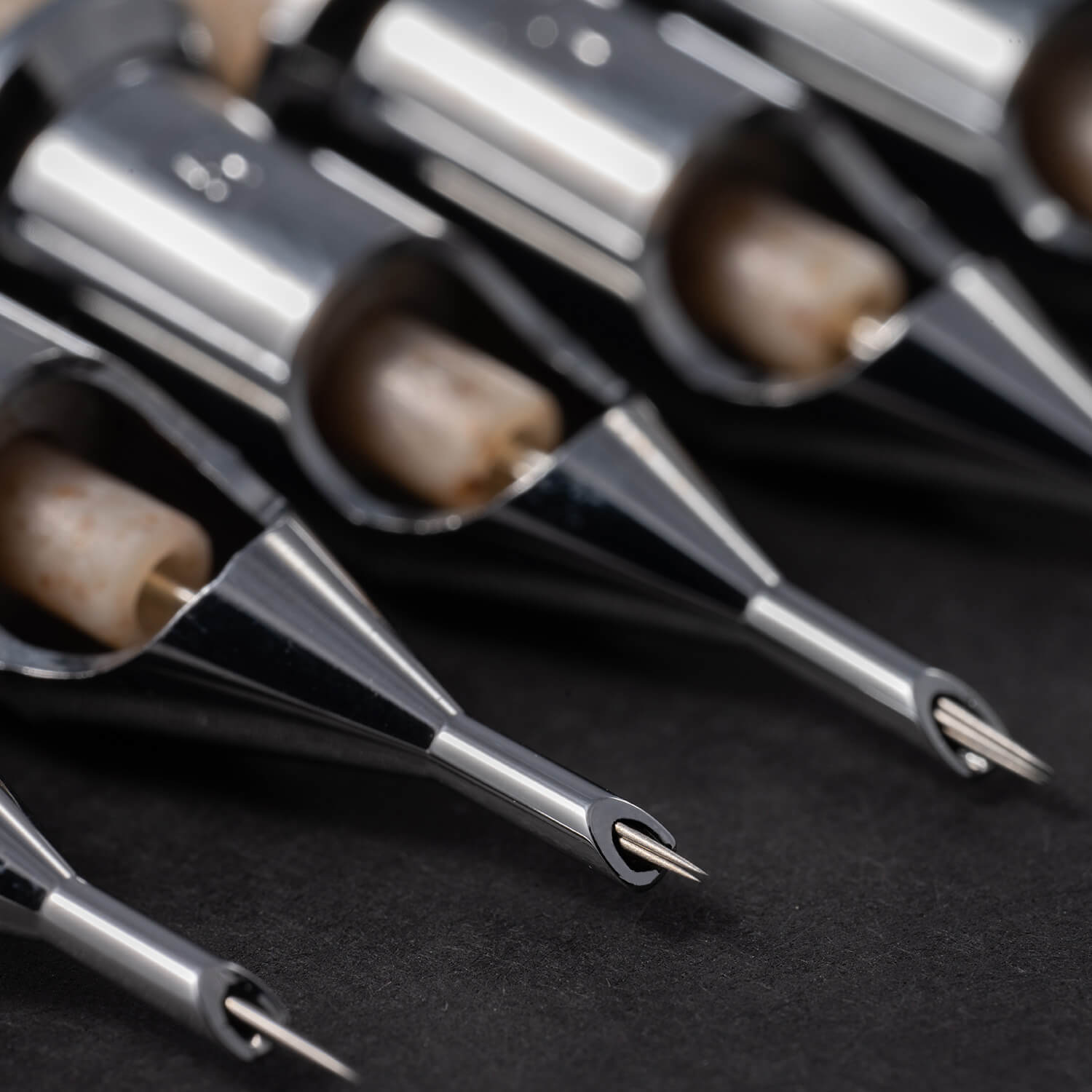 A close-up of different needle sizes of the TATSoul ENSO premium tattoo cartridges.