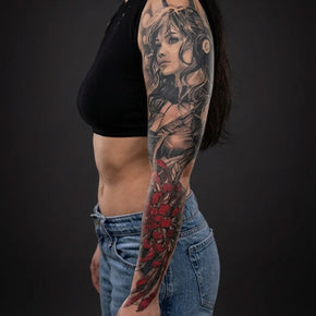 Sleeve tattoo featuring a detailed portrait and floral design on a woman’s arm.