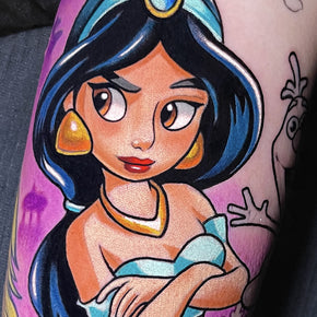 Tattoo of an animated character wearing a blue outfit and gold earrings.