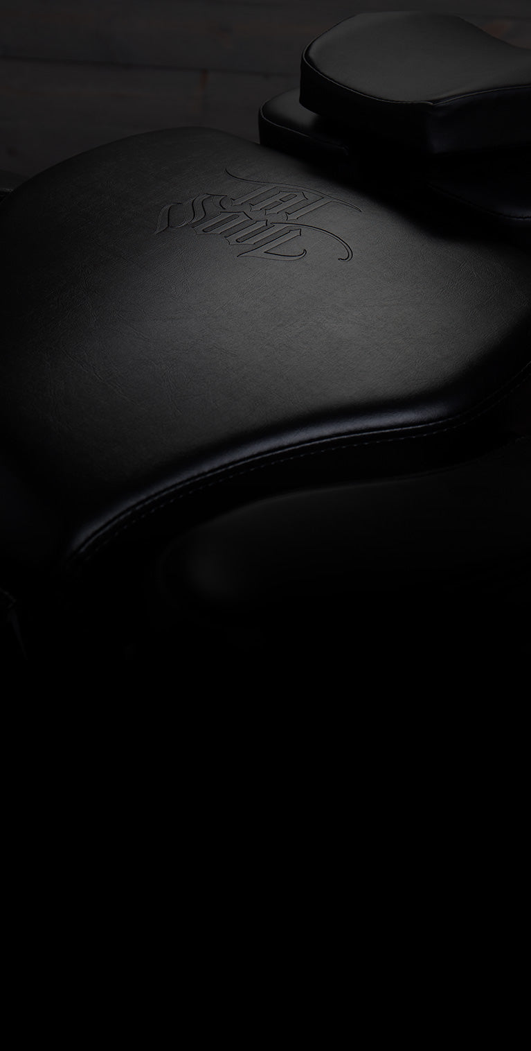 Close-up of a black TATSoul tattoo chair seat.