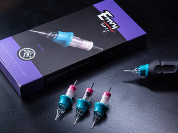 Tattoo needle cartridges and packaging on a surface.