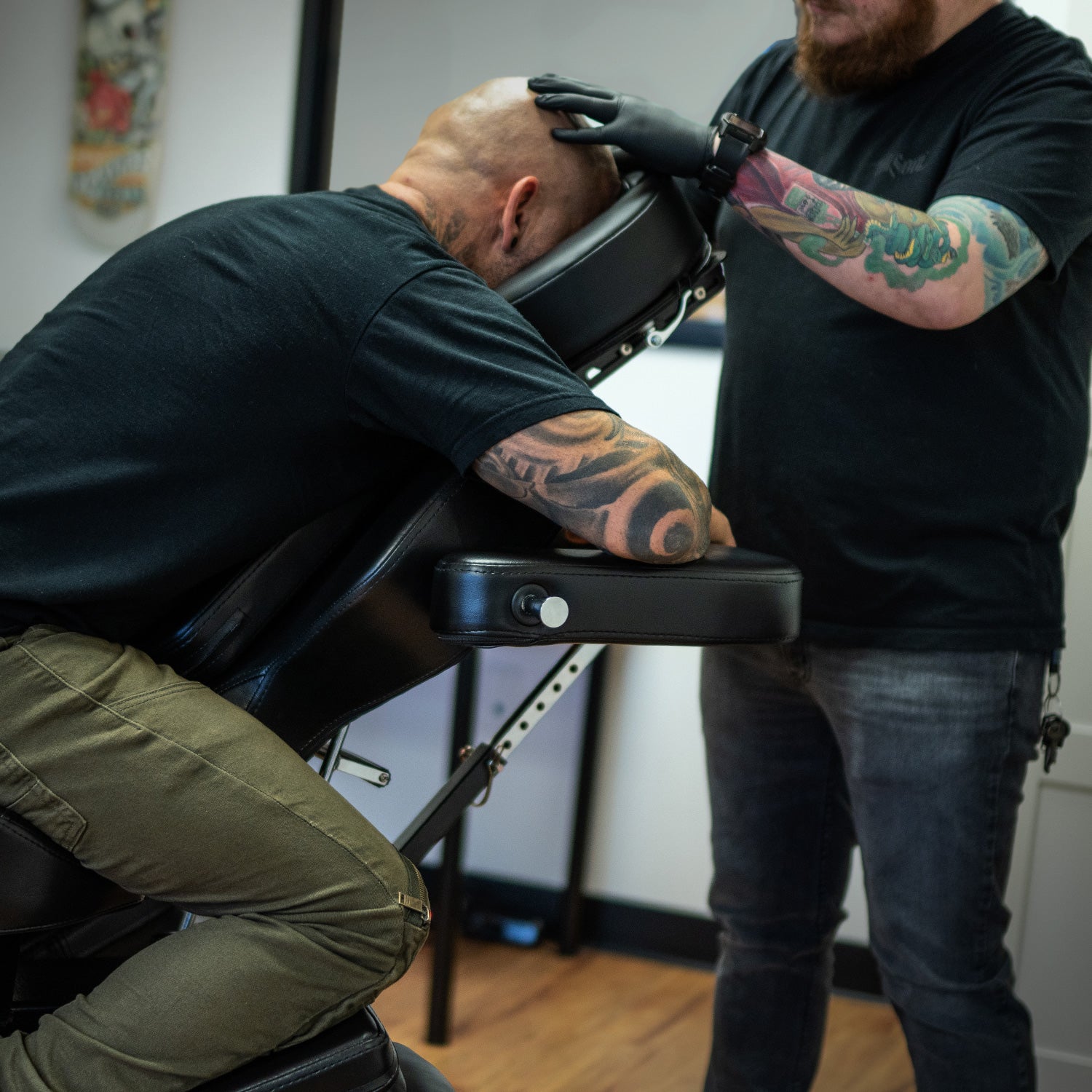 Tattoo client using TATSoul Scalp Headrest Comfort Bundle while being tattooed.