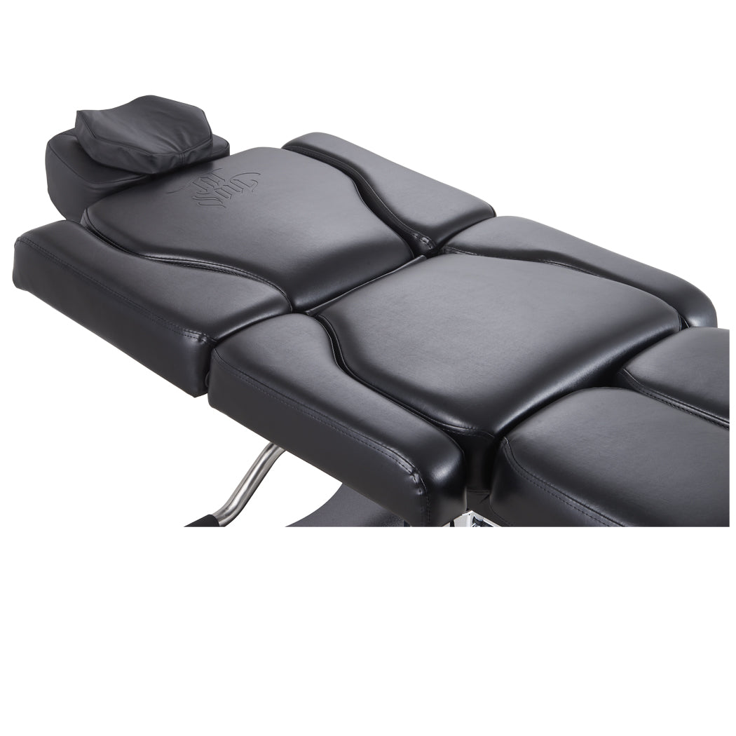 The tattoo client chair bed with a removable pillow and plush face hole for face-down position.