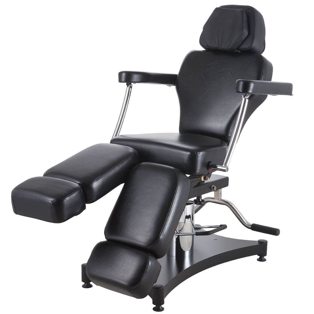 The Oros 680 Tattoo Client Chair with one leg of the chair above the other showing versatility of parts for this client chair. 