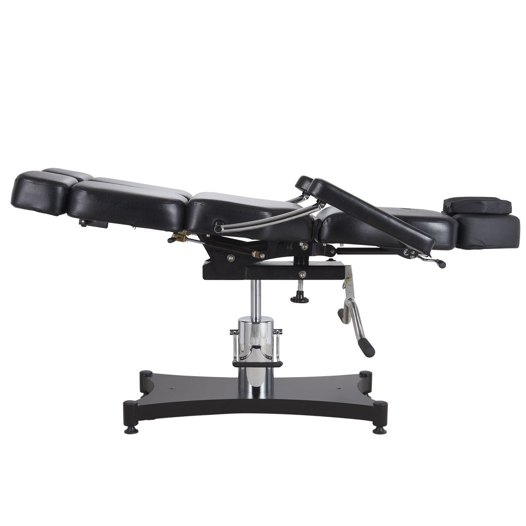 Oros 680 Tattoo Client Chair side view in a laid down position with the leg rest tilted slightly up.