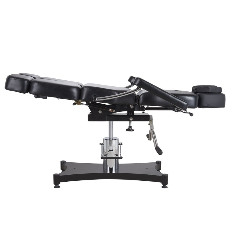 Oros 680 Tattoo Client Chair side view in a laid down position with the leg rest tilted slightly up.