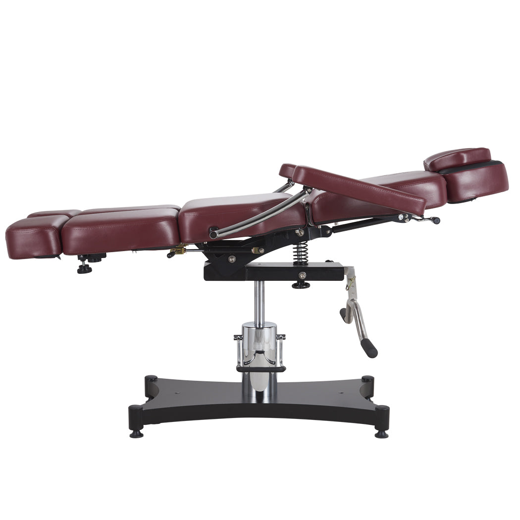 Oros 680 Tattoo Client Chair, Oxblood color, side view in a laid down position with backrest tilted slightly up.