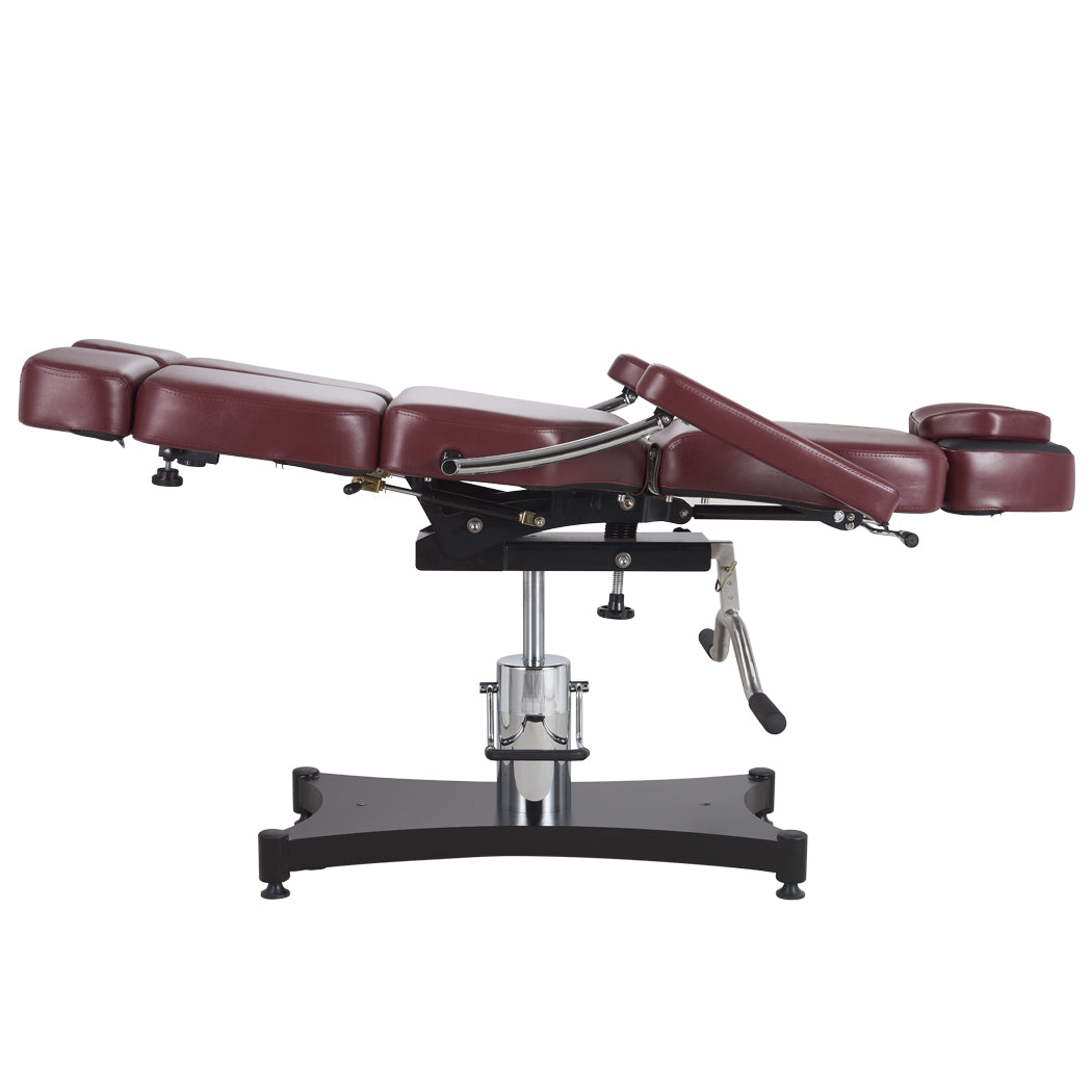 Oros 680 Tattoo Client Chair, Oxblood color, side view in a laid down position with leg rest tilted slightly up.