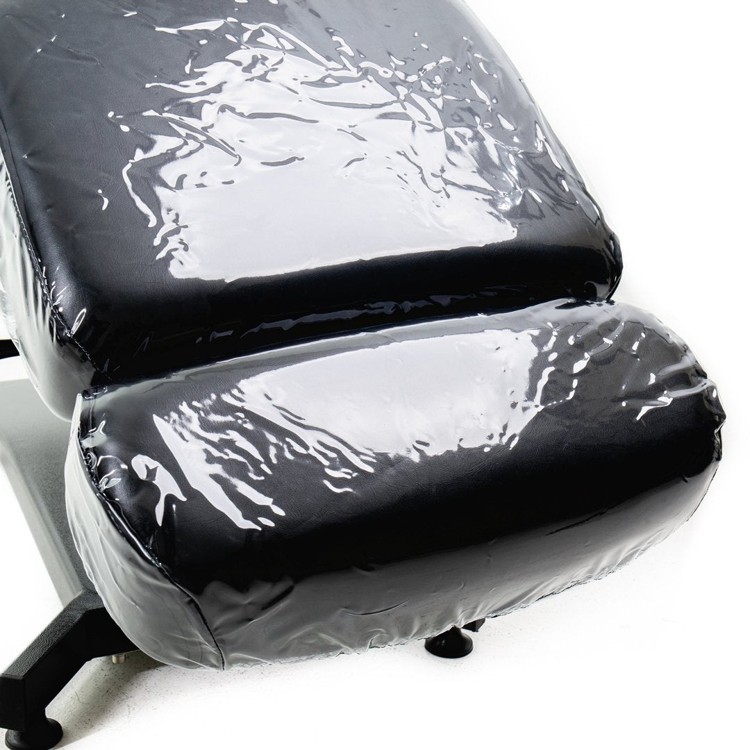 TATSoul 300 Slim Tattoo Client Chair in fully laid down position wrapped in plastic protective cover